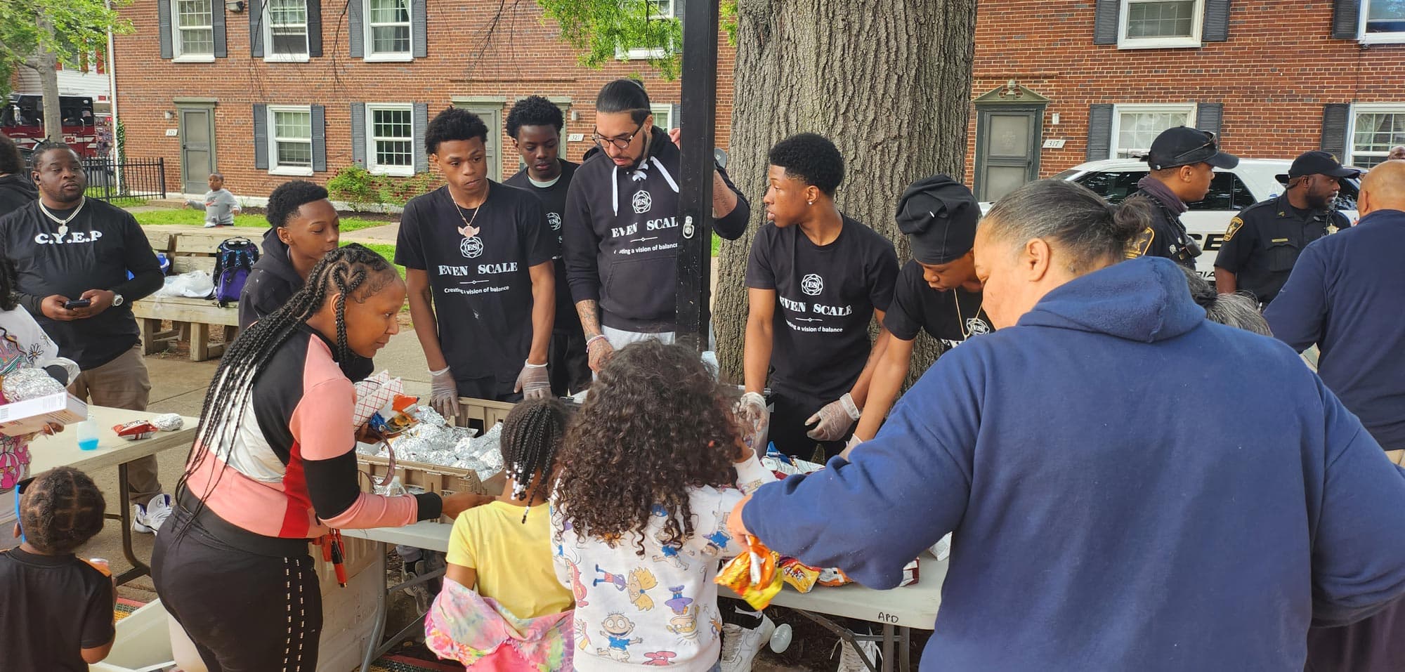 Apprentices passing out food at an APD community cookout.