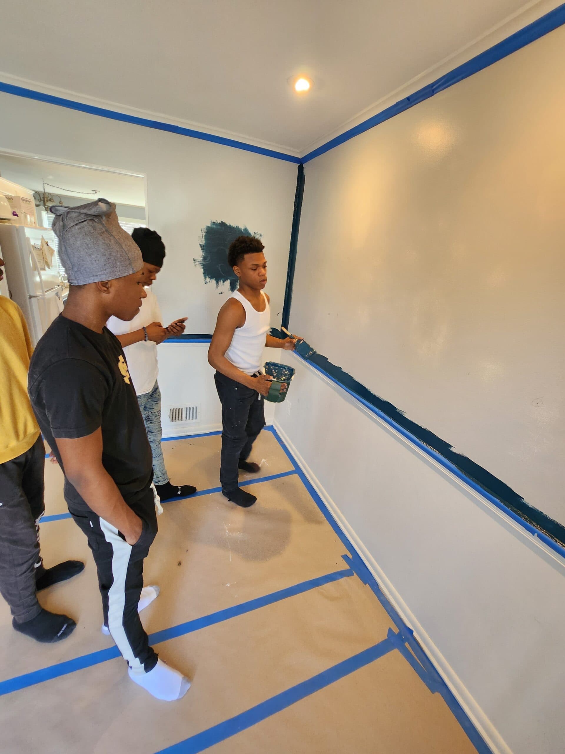 Apprentices getting familiar with paintbrushes and cutting techniques.