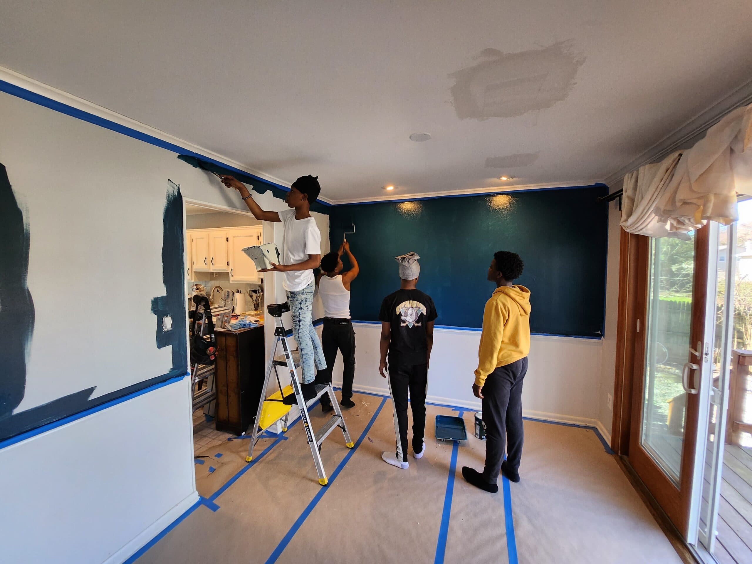 Apprentices painting an accent wall.