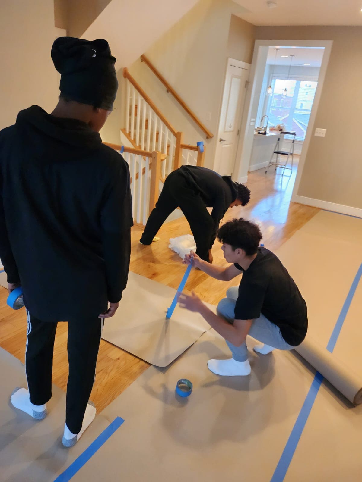 Apprentices becoming familiar with floor covering needed before painting.