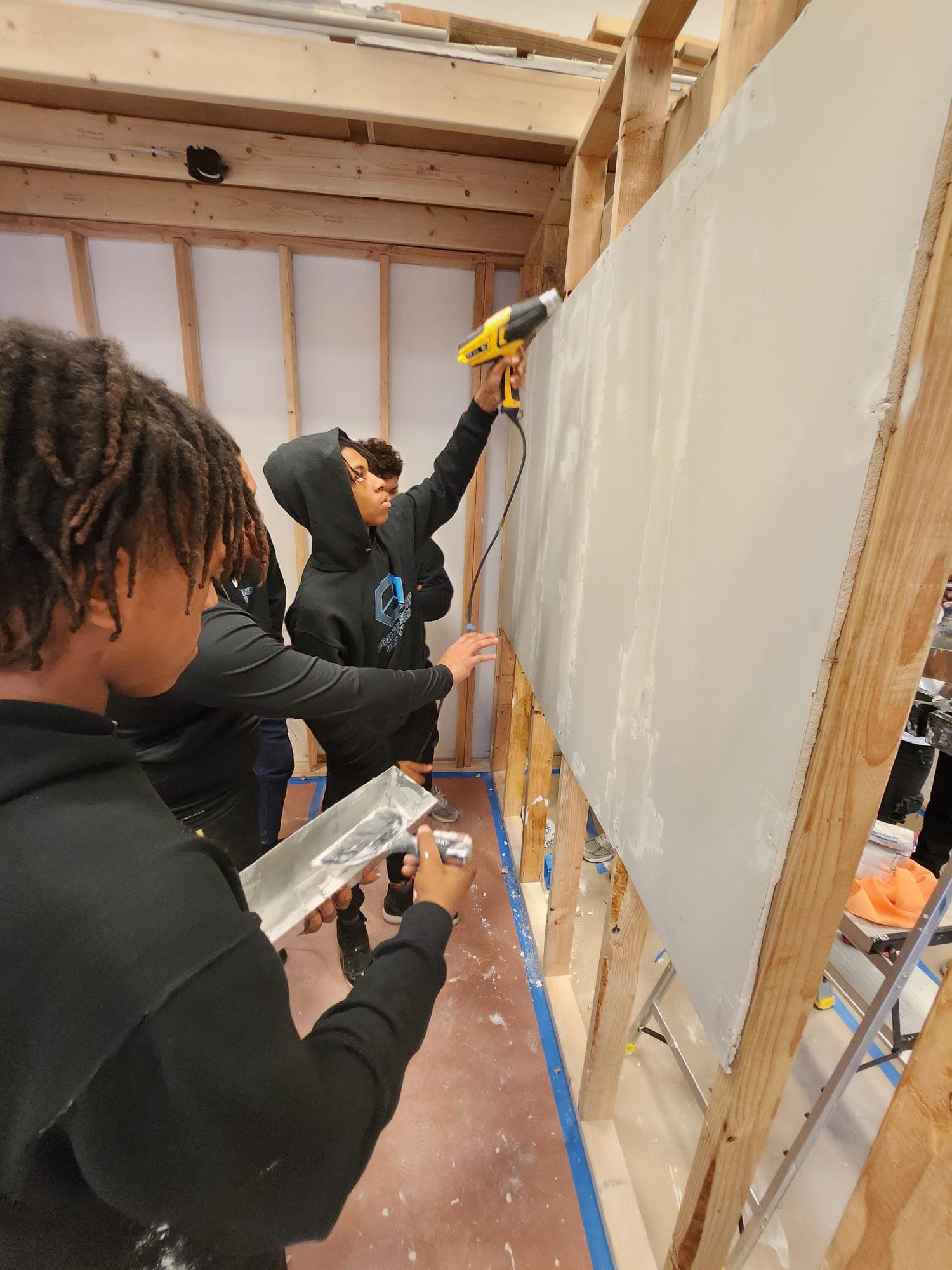 Students in the next stages of working with plaster and a heat gun.