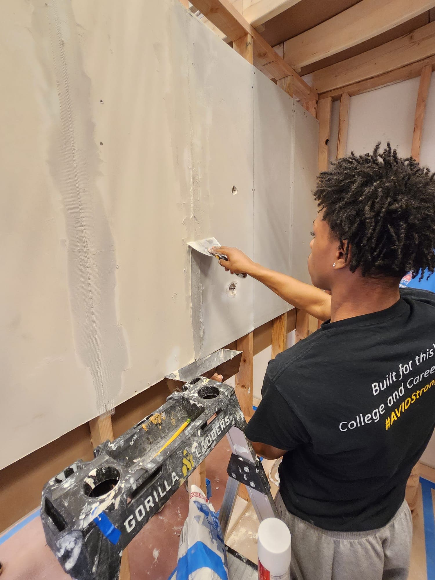 Student working with plaster and plaster tools.